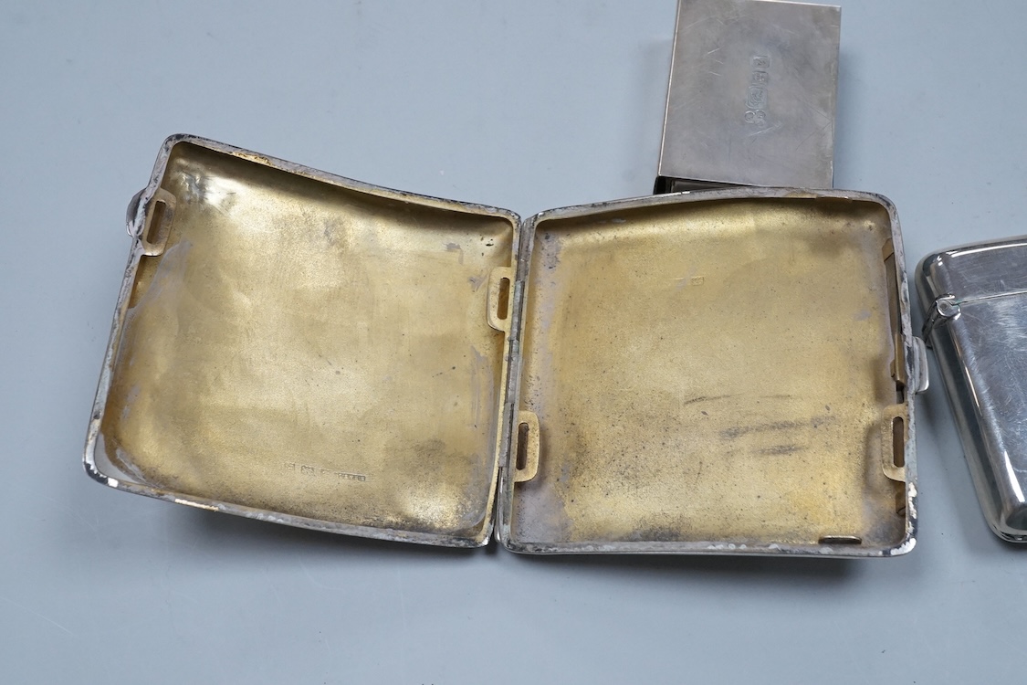 A George V engraved silver cigarette case, Birmingham, 1930, 82mm, a similar silver vesta case, London, 1913 and two silver matchbox sleeves.